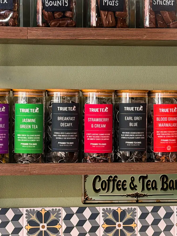 Wall of True Tea Co tea jars at Toastea